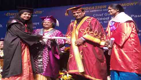 A medical student receiving her degree at the 103 convocation of LHMC