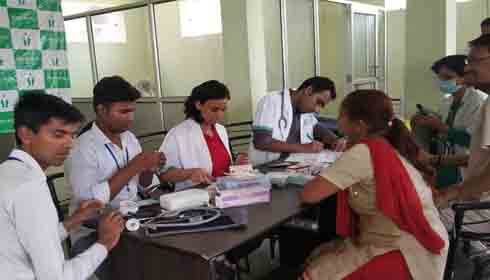 Patients getting free services at Hisar health camp